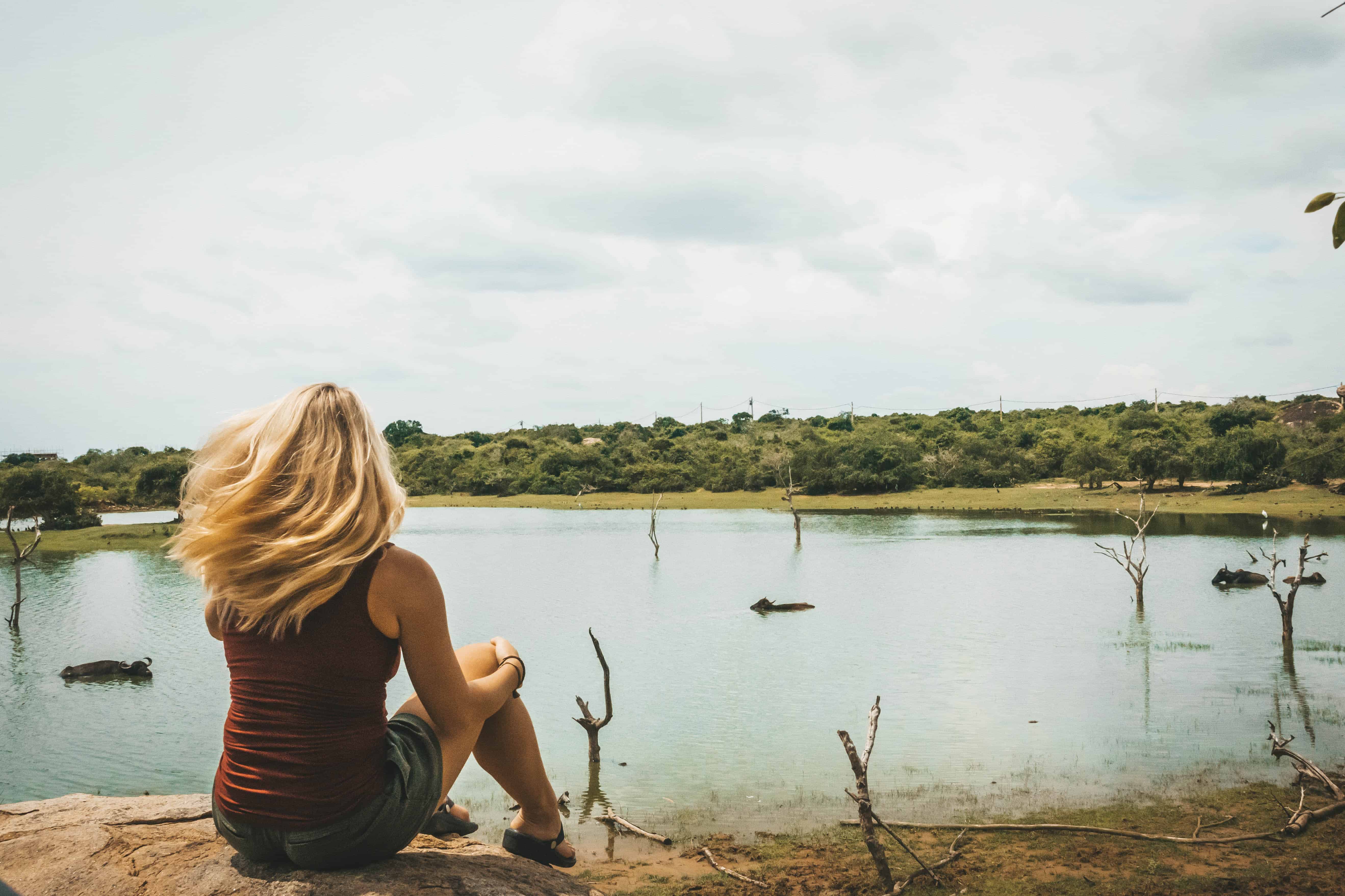 Natasha Sits In Front Of Watering Hole In Yala National Park, Sri Lanka