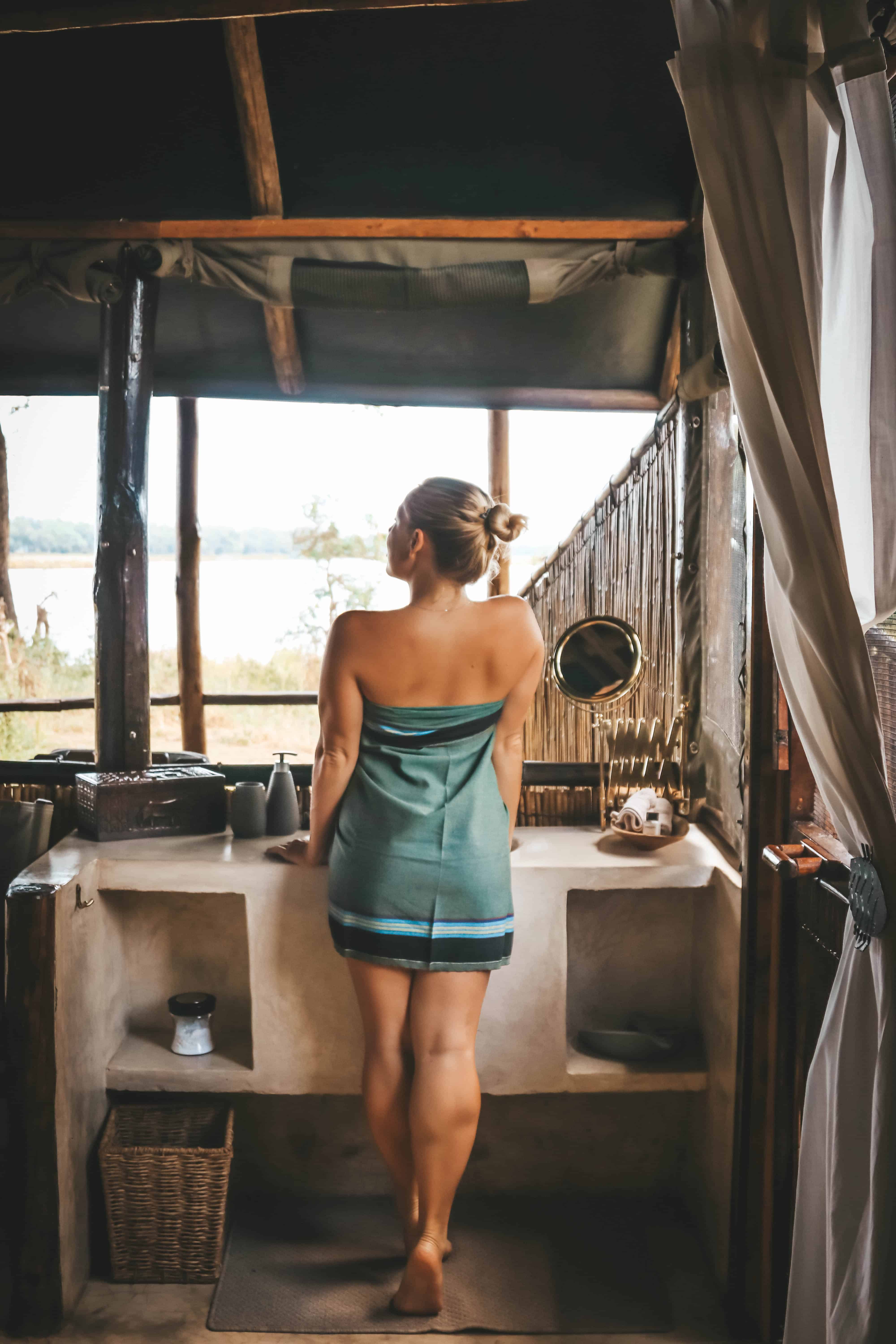 clothes in Africa barefoot in the bathroom of safari lodge