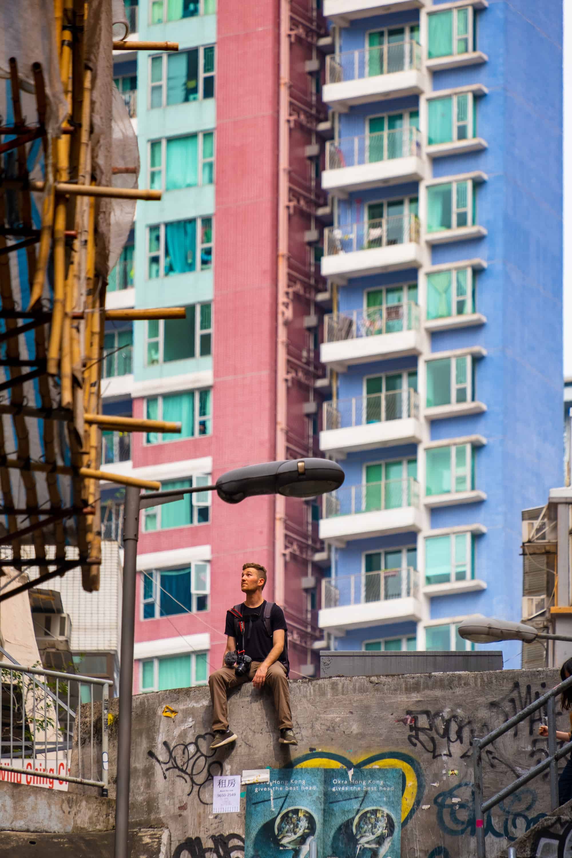 Cameron Sitting In Hong Kong Cityscape