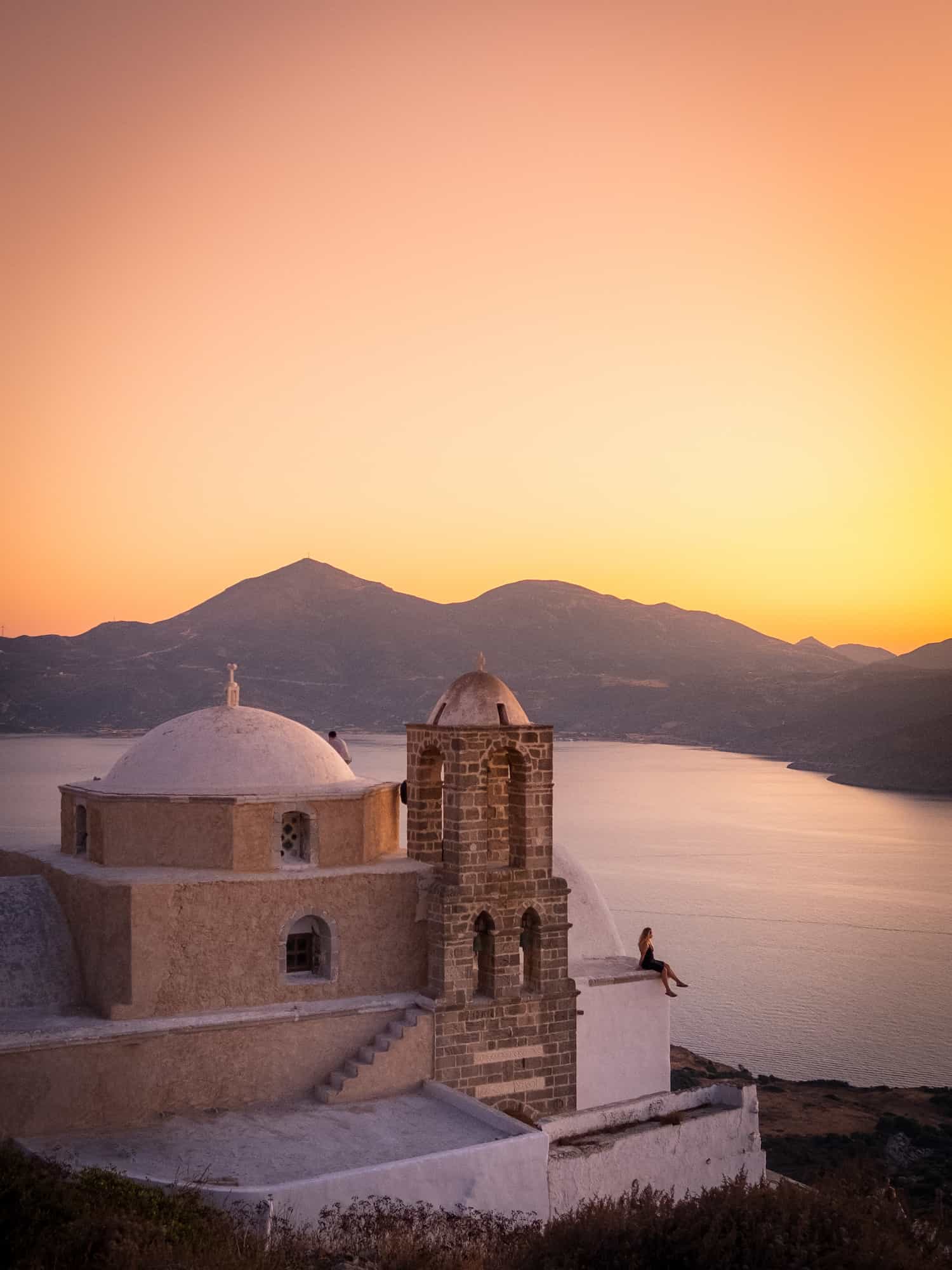 Natasha Sits Alone On Church At Sunset On Milos