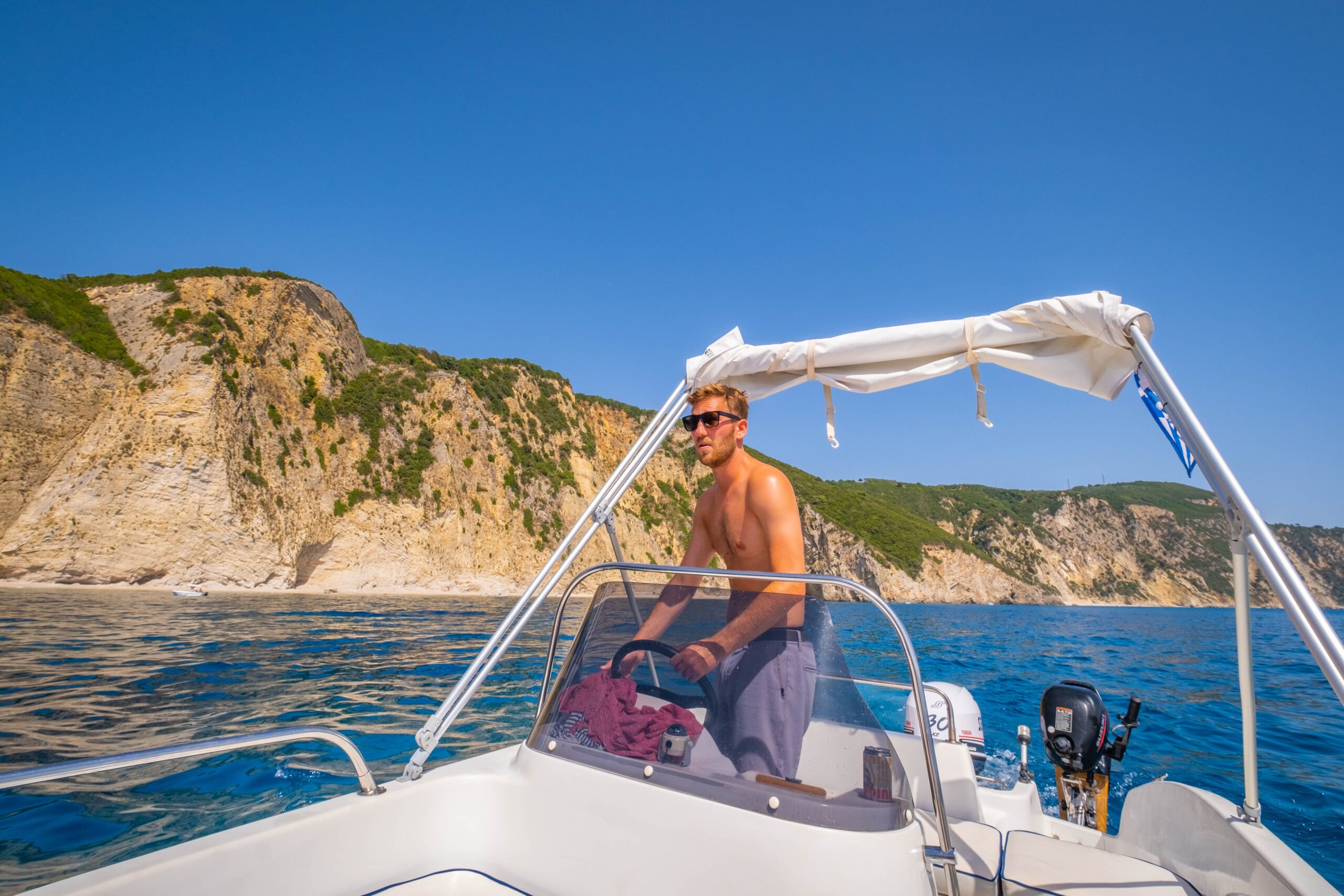 Cameron Driving A Boat On Kefalonia