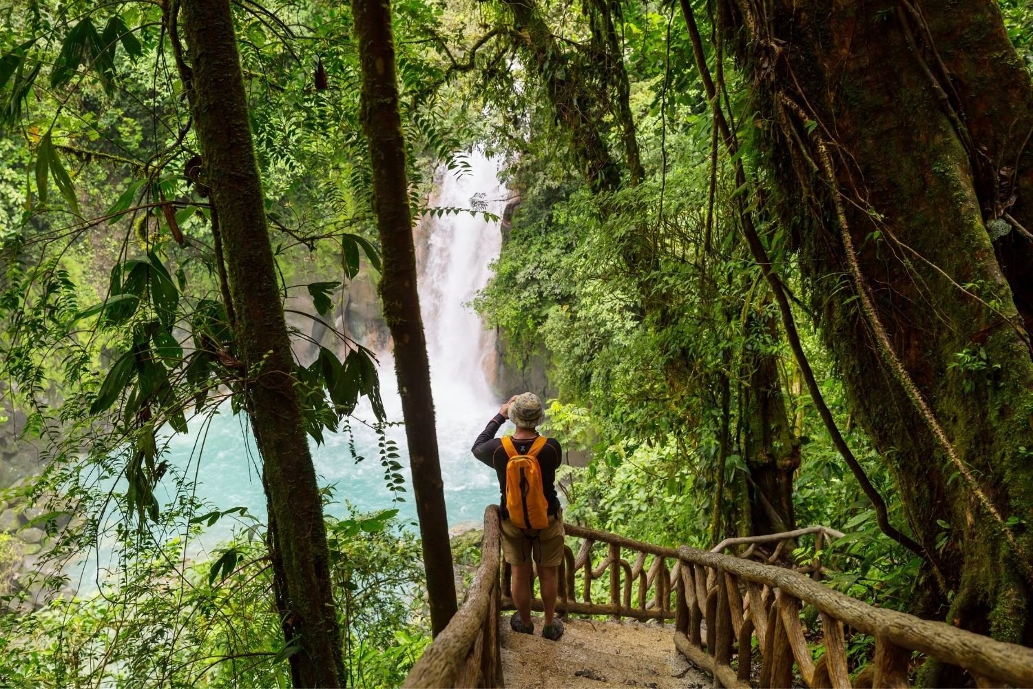 Hiker In Costa Rica Taking a Photo of Waterfall